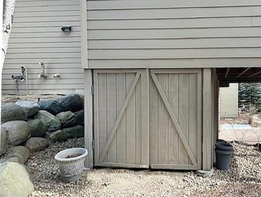 Storage enclosure is hidden under the porch