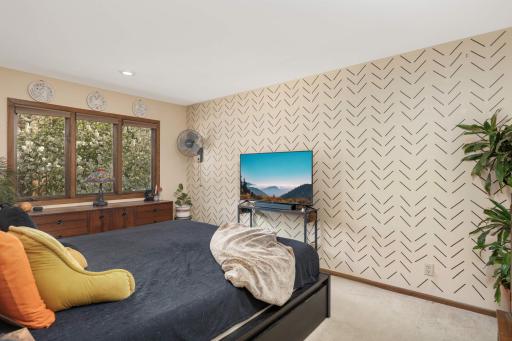 The primary bedrooms is spacious enough to fit your sizable furniture, and features a large window with views of nature.