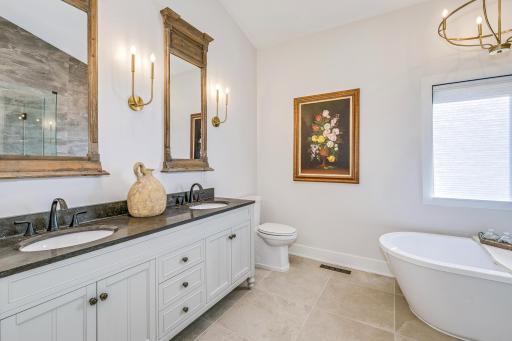 Primary ensuite bathroom. Full bath, features dual vanity, stand-alone soaking tub, glass surround shower. 'Calgon - take me away!'