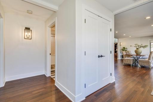 Entry guest coat closet, hallway to 1st guest room and main floor full bath.