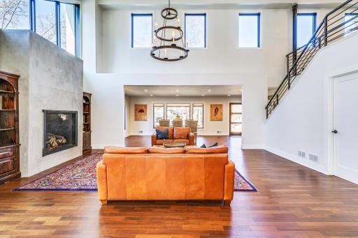 Notice the industrial / contemporary / custom banister leading one to the upper-level loft.