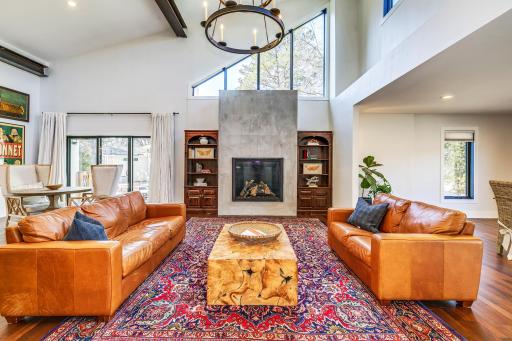 Main level living / informal dining, crowned with a unique and eye-catching chandelier. This space features a large access patio / sliding glass door leading to the stamped, entertainment sized, concrete patio.