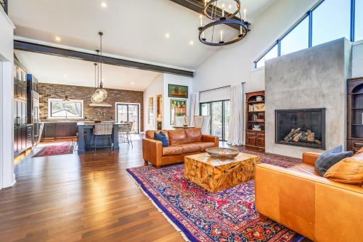 Main level living / dining / kitchen spaces. Complete with a stoic Vienitian inspired gas fireplace that graces the space with a grand and glorious focal point.