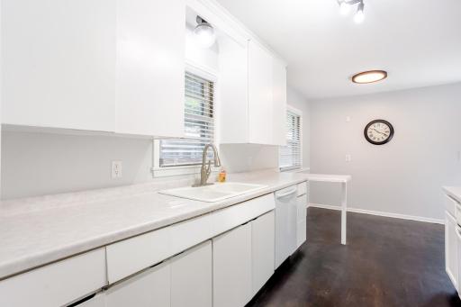 Convenient breakfast bar, double windows, and stylish lighting bring both utility and charm.