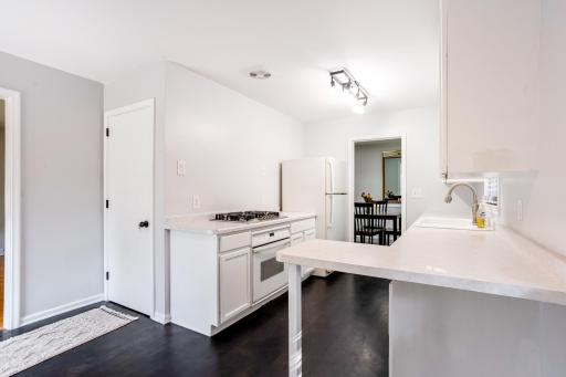 Functional kitchen layout with a gas cooktop and easy access to formal dining area.