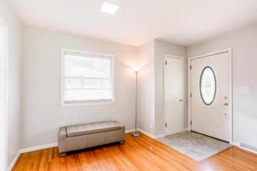 Stylish front entry with tiled floor and coat closet, offering a clean and functional first impression.
