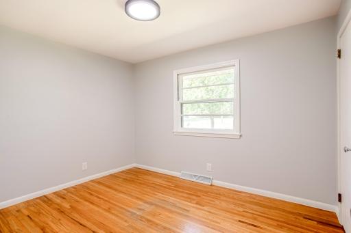 A look through the second door offers convenient access to both the main living spaces and other bedrooms.