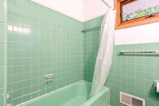 Classic tiled shower/tub combo with vintage charm.