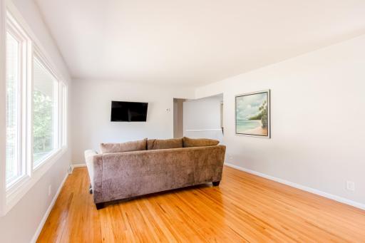 Spacious living room featuring a mounted TV and ample natural lightâperfect for relaxation or entertaining.