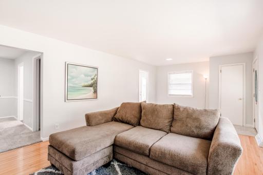 Comfortable and open layout with seamless flow from the living room to adjacent dining room and kitchen.