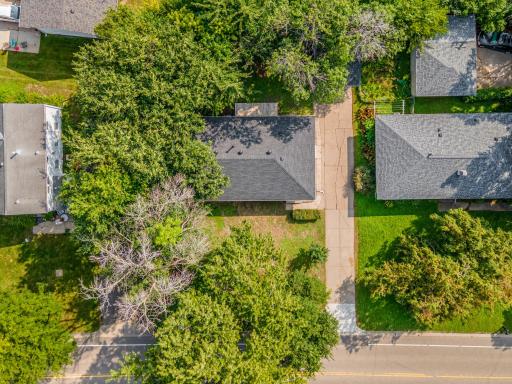 Birdâs-eye view of the home nestled on a well-sized lot with mature trees and easy access to nearby amenities.