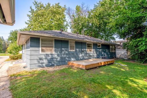 Private backyard offering room to expand or garden, with direct access to the elevated rear deck.