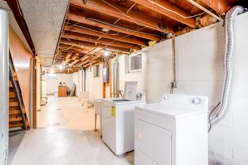 Open lower level with laundry, utilities, and great potential for workshop, storage, or future finish.