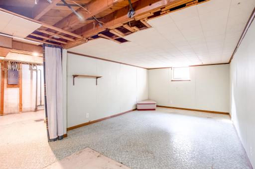 Lower-level family room with window and vinyl flooringâgreat for a home office, playroom, or rec space.