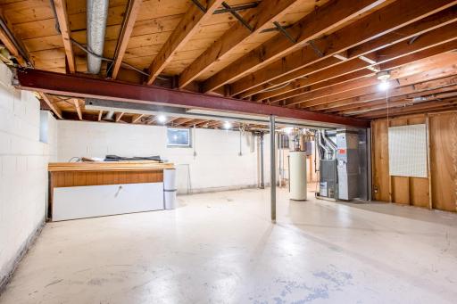 Multi-use unfinished basement area with open space for future improvements.