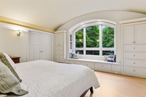 Primary suite - offers expansive ceilings and a gorgeous arch window view.