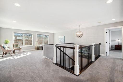 Large loft area separating the 2 bedrooms on the 2nd floor with closet for storing your games or extra toys.