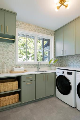Upper level laundry. Plenty of cabinetry and counter space