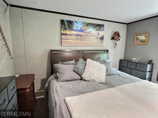 Enter the primary bedroom and you will be impressed with the space it provides and the great views the woods behind you.