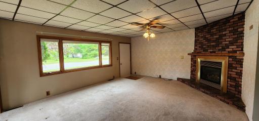 Living room with large front window and fireplace