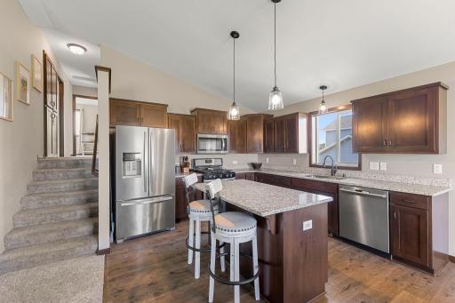 The kitchen is a showstopper with rich wooden cabinetry, granite counter tops, and a large center island.