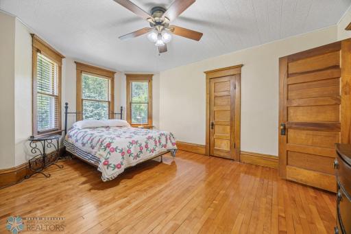 Primary Bedroom, with hardwood floors, tons of natural light and an en-suite bath - with soaking tub! Also has 2 closets! One is a walk-in.