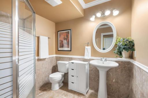 Lower level 3/4 bathroom with marble flooring