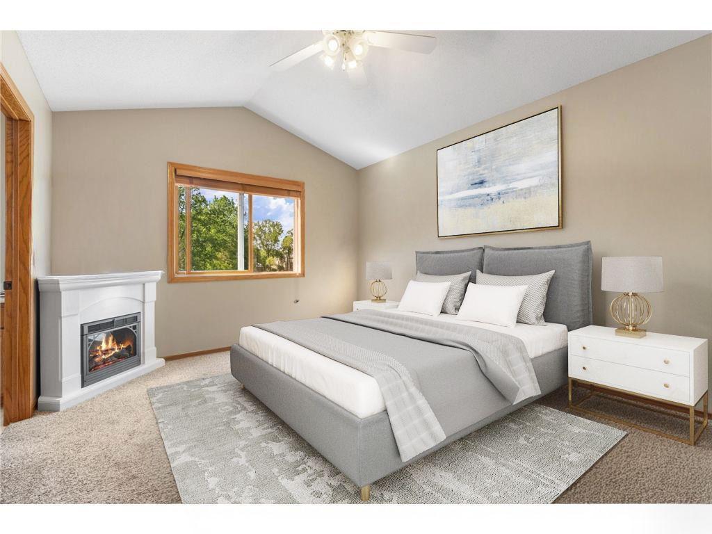Primary Bedroom with vaulted ceiling and ceiling fan- virtually staged