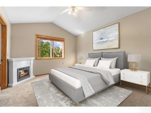 Primary Bedroom with vaulted ceiling and ceiling fan- virtually staged