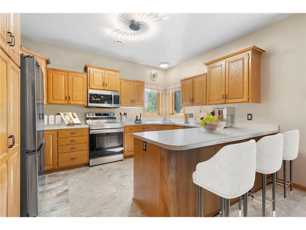 Kitchen with updated appliances, marble floors and custom oak cabinetry