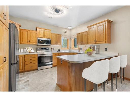 Kitchen with updated appliances, marble floors and custom oak cabinetry