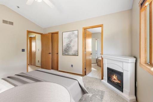 Primary Bedroom with electric fireplace and ensuite- virtually staged