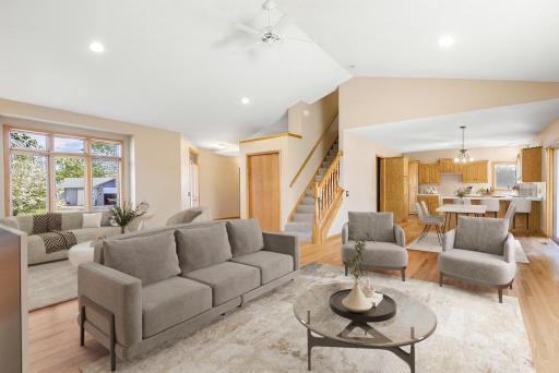Vaulted ceiling with ceiling fan and hardwood floors- virtually staged