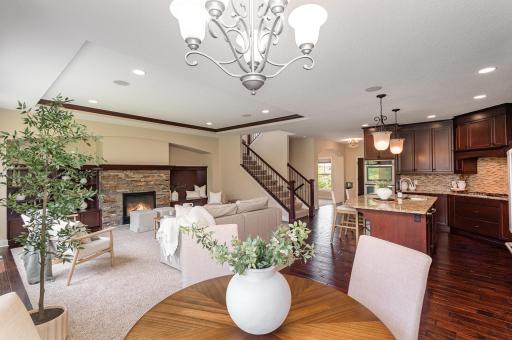 Stunning open concept kitchen, living & dining room. With cherry cabinetry, crown moding and slate fire place surround.