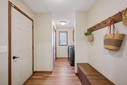 A functional mudroom with a built-in bench and wall hooks provides for daily organization.