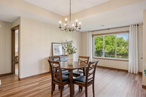 The dining space features a large window and access to the screened porch and backyard.