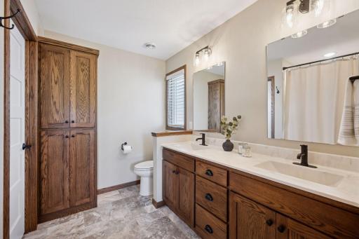 Dual sinks, rich cabinetry, and abundant storage make this space both elegant and functional.