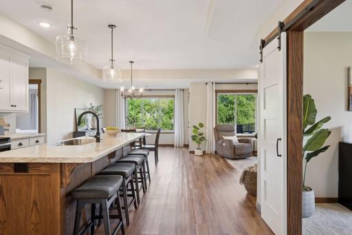 The open layout connects the kitchen, dining, and living rooms, offering a modern living space that combines style and convenience. Access the porch from the dining room. The adjacent room to the main living area can serve as home office or den.