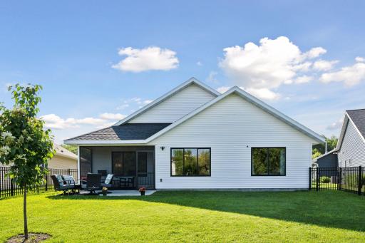 A charming backyard with a fenced-in lawn and patio space is perfect for pets, entertaining, or peaceful outdoor living.