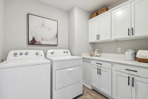 Large laundry room with cabinets.