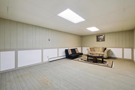 Images 11 and 12 depict the fourth level which offers versatility. This space can be used for a playroom daycare or mother in law suite