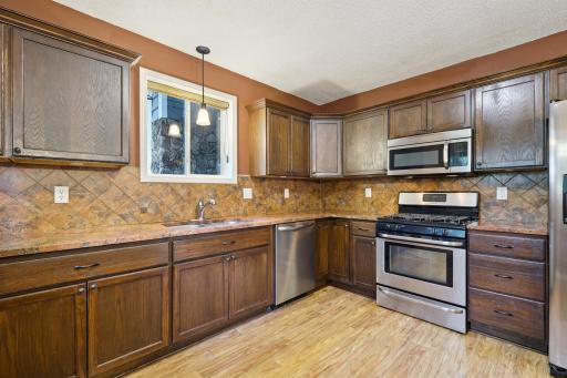 Upgraded granite countertops with stainless steel appliances throughout the kitchen.