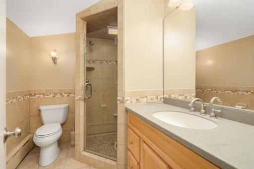 Private primary en suite bathroom with walk in shower.