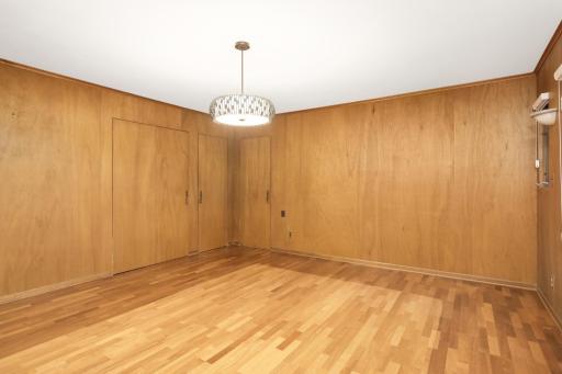 Unique fully paneled walls conceal a wet bar, 1/2 bathroom and access to the main floor den!