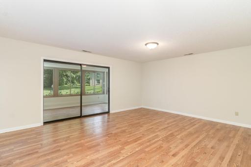 Living room looking into a porch with view of gardens