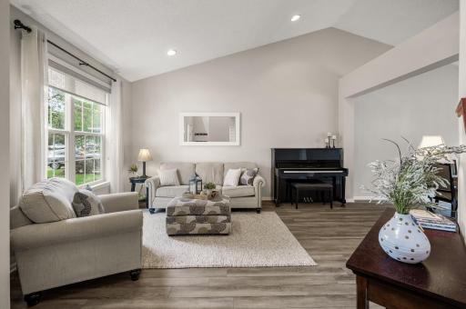 Vaulted living room is open to the formal dining room, perfect for entertaining