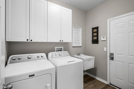 Main floor laundry/mud room with a utility sink
