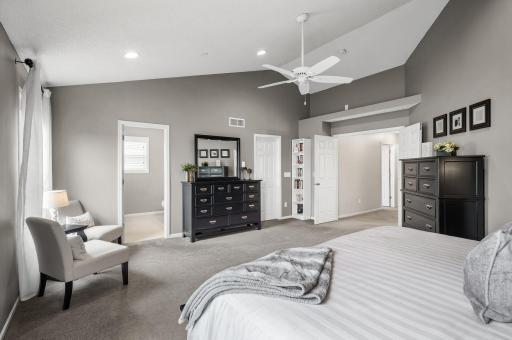 Primary suite with a view of the door to the closet and full bath
