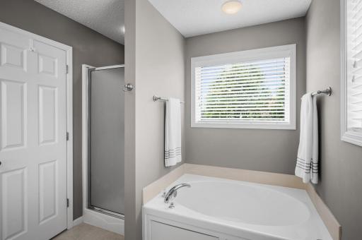 Primary oversized soaking tub and separate shower