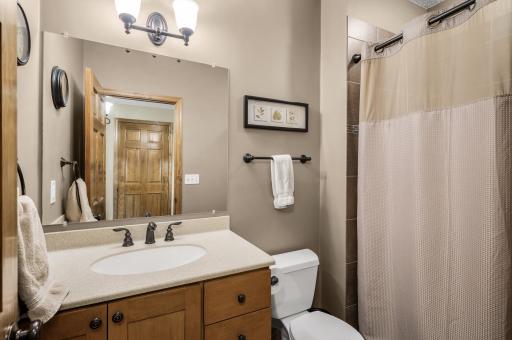 Lower level three-quarter tile bath
